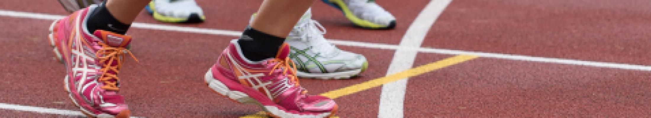 close up of shoes runnign on a track